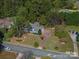 An aerial view of a landscaped property featuring mature trees, a long driveway, and beautiful home at 3664 Gaston Day School Rd, Gastonia, NC 28056
