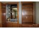 Classic home bar area with mirrored backsplash, granite countertop, and beautiful wood cabinets at 3664 Gaston Day School Rd, Gastonia, NC 28056
