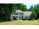 Charming two-story home featuring a well-manicured lawn with mature trees and inviting curb appeal at 3664 Gaston Day School Rd, Gastonia, NC 28056