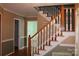 A traditional foyer featuring wooden stairs and an open entryway with warm tones at 3664 Gaston Day School Rd, Gastonia, NC 28056