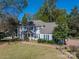 Charming two-story home with a well-manicured front yard and beautiful mature trees at 3664 Gaston Day School Rd, Gastonia, NC 28056