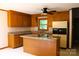 Eat-in kitchen features granite countertops, central island, and wood cabinets at 3664 Gaston Day School Rd, Gastonia, NC 28056