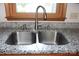 Double basin stainless steel sink with granite countertop and wood framed window at 3664 Gaston Day School Rd, Gastonia, NC 28056