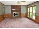 Bright living room featuring a brick fireplace and large windows, offering ample natural light at 3664 Gaston Day School Rd, Gastonia, NC 28056