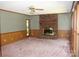 Spacious living room featuring a brick fireplace and large windows with a ceiling fan at 3664 Gaston Day School Rd, Gastonia, NC 28056