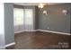Cozy living room features hardwood floors, neutral wall color, and bright, natural light at 3664 Gaston Day School Rd, Gastonia, NC 28056