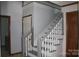 Staircase with gray steps and white railing with a door nearby at 3664 Gaston Day School Rd, Gastonia, NC 28056
