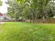 Expansive backyard featuring a lush lawn, mature trees, and a wooden privacy fence at 3905 Brittany Ct, Indian Trail, NC 28079