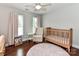Cozy bedroom with hardwood floors, crib, and accent chair at 3905 Brittany Ct, Indian Trail, NC 28079