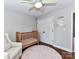 Charming bedroom with crib, accent chair, and double door closet at 3905 Brittany Ct, Indian Trail, NC 28079