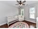 Cozy Bedroom with hardwood floors, crib, and accent chair at 3905 Brittany Ct, Indian Trail, NC 28079