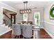 Dining room with modern lighting, hardwood floors, and elegant chair detail at 3905 Brittany Ct, Indian Trail, NC 28079
