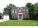 Traditional two-story brick home with well-manicured lawn and attached two-car garage at 3905 Brittany Ct, Indian Trail, NC 28079