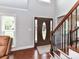 Bright foyer with hardwood floors and staircase, showcasing a decorative front door at 3905 Brittany Ct, Indian Trail, NC 28079