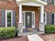 Close up of front entrance with stone accents and welcoming door wreath at 3905 Brittany Ct, Indian Trail, NC 28079