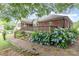 Brick and gravel pathway with lush landscaping leading to the house at 43 Paddington Sw Dr, Concord, NC 28025
