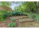 Brick steps through the garden leading to the backyard at 43 Paddington Sw Dr, Concord, NC 28025
