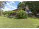 Well-maintained backyard featuring lush green grass and mature trees at 43 Paddington Sw Dr, Concord, NC 28025