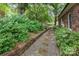 Gravel and brick pathway with lush greenery bordering the property at 43 Paddington Sw Dr, Concord, NC 28025