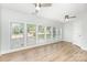 Bright bedroom featuring lots of windows, two ceiling fans and light wood floors at 43 Paddington Sw Dr, Concord, NC 28025