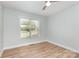A bright bedroom with light walls, wood floor and window at 43 Paddington Sw Dr, Concord, NC 28025