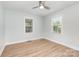 A light filled bedroom with light green walls, wood floor and windows at 43 Paddington Sw Dr, Concord, NC 28025