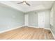 A spacious bedroom with light green walls, wood floor, a ceiling fan and many windows at 43 Paddington Sw Dr, Concord, NC 28025