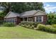 Charming brick home featuring a manicured front yard and lush landscaping, and mature trees in a desirable neighborhood at 43 Paddington Sw Dr, Concord, NC 28025
