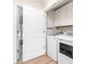 Laundry room features white cabinetry, a washer and a dryer at 43 Paddington Sw Dr, Concord, NC 28025