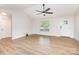 Spacious living area with wood flooring, vaulted ceiling, bright windows, and neutral paint providing versatile design at 43 Paddington Sw Dr, Concord, NC 28025