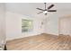 Open-concept living space with wood flooring, vaulted ceiling, large windows, and great natural light at 43 Paddington Sw Dr, Concord, NC 28025