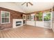Covered porch with brick fireplace, wood beams and deck flooring at 43 Paddington Sw Dr, Concord, NC 28025