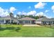 A well-maintained backyard with lush green grass and a view of the patio and surrounding homes at 4420 Bright Rd, Charlotte, NC 28214
