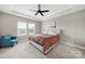 Bright bedroom boasts large windows and tray ceilings at 4420 Bright Rd, Charlotte, NC 28214