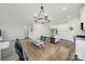 Open dining area and kitchen with hardwood floors and stylish light fixtures at 4420 Bright Rd, Charlotte, NC 28214