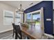 Dining area featuring a wooden table with modern lighting and sliding glass doors to the backyard at 4420 Bright Rd, Charlotte, NC 28214