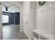 Inviting entryway with coat rack, seating, and convenient access to the living area at 4420 Bright Rd, Charlotte, NC 28214