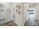 Bright hallway with hardwood floors leading to bedrooms and bathrooms, adorned with framed maps at 4420 Bright Rd, Charlotte, NC 28214