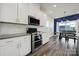 Modern kitchen with stainless steel appliances, white subway tile backsplash, and an adjacent dining area at 4420 Bright Rd, Charlotte, NC 28214
