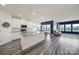 Open-concept kitchen and living area with white cabinets, granite countertops, and stainless steel appliances at 4420 Bright Rd, Charlotte, NC 28214