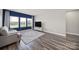 Comfortable living room with hardwood floors, a large window, and a cozy sofa at 4420 Bright Rd, Charlotte, NC 28214