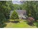 Captivating aerial shot of the backyard showcasing a well-maintained lawn and inviting deck surrounded by mature trees at 4605 Sarandon Ct, Charlotte, NC 28215