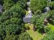 Aerial view of a secluded home nestled among lush green trees and mature landscaping, offering privacy at 4605 Sarandon Ct, Charlotte, NC 28215