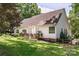 Charming white home featuring a spacious wooden deck, lush lawn, and beautifully landscaped backyard, perfect for outdoor enjoyment at 4605 Sarandon Ct, Charlotte, NC 28215