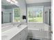 Bright bathroom with a large soaking tub, walk-in shower, and double vanity with modern fixtures at 4605 Sarandon Ct, Charlotte, NC 28215
