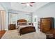 Spacious primary bedroom with neutral tones, a ceiling fan, and a view of the ensuite bathroom at 4605 Sarandon Ct, Charlotte, NC 28215