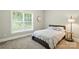 Comfortable bedroom featuring a large window providing natural light and cozy carpeting at 4605 Sarandon Ct, Charlotte, NC 28215