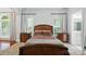 Cozy bedroom featuring natural light, a wooden bed frame, and matching nightstands at 4605 Sarandon Ct, Charlotte, NC 28215