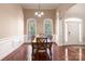 Charming dining room featuring hardwood floors, wainscoting, and natural light streaming through large windows at 4605 Sarandon Ct, Charlotte, NC 28215