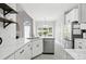 Bright, modern kitchen with white cabinets, stainless steel appliances, and open layout at 4605 Sarandon Ct, Charlotte, NC 28215
